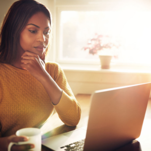 Women at computer with coffee cup
